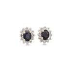 A PAIR OF DIAMOND AND SAPPHIRE CLUSTER EARRINGS, the circular sapphire to diamond surround,