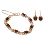 A GARNET BRACELET, in 9ct gold with matching earrings, 16.7 g.