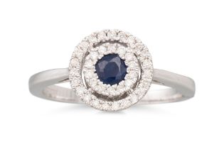 A DIAMOND AND SAPPHIRE CLUSTER RING, the circluar sapphire to a two rowed diamond surround,