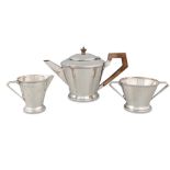 A MODERN SILVER THREE PIECE TEA SERVICE OF SHAPED PLAIN FORM, comprising a tea pot, twin handled