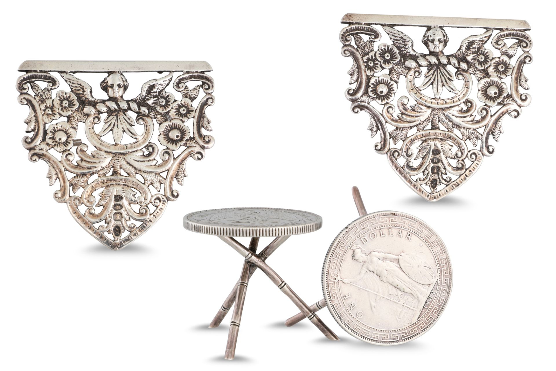A PAIR OF SILVER NOVELTY TABLES, a Mexican Peso 1901 coin tops with a Victorian large silver nurse's