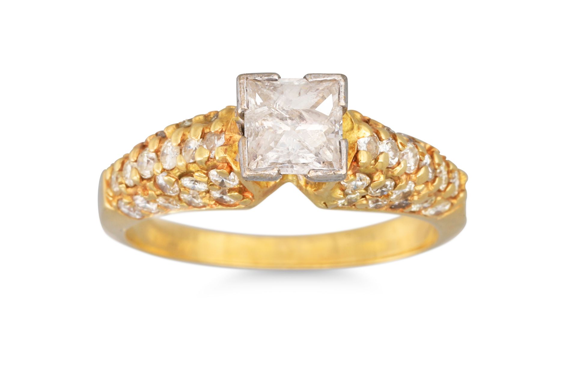 A DIAMOND PRINCESS CUT DRESS RING, with diamond shoulders, mounted in yellow gold. Estimated: weight