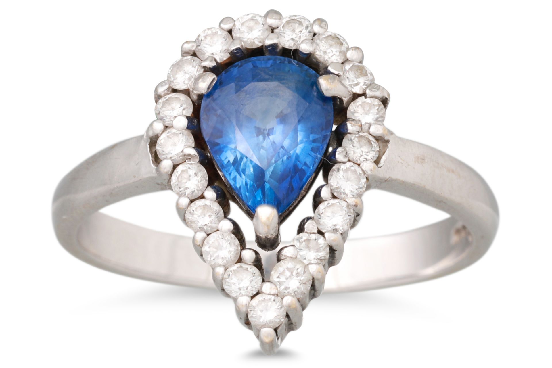 A SAPPHIRE AND DIAMOND CLUSTER RING, the central pear shaped sapphire to a diamond surround, mounted