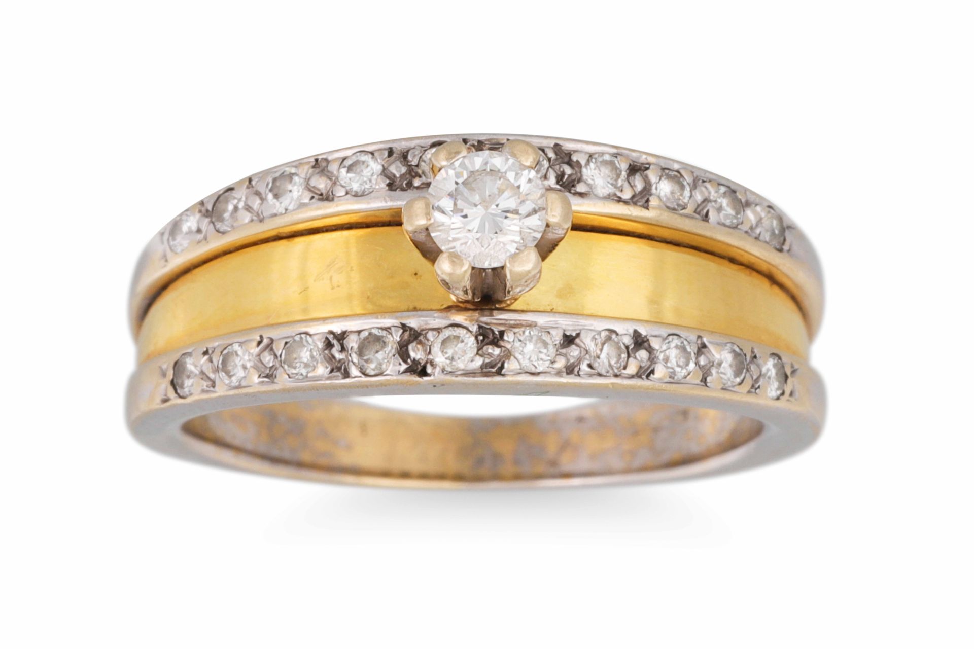 A DIAMOND SOLITAIRE RING, the round brilliant cut diamond to diamond border, in two colour gold.