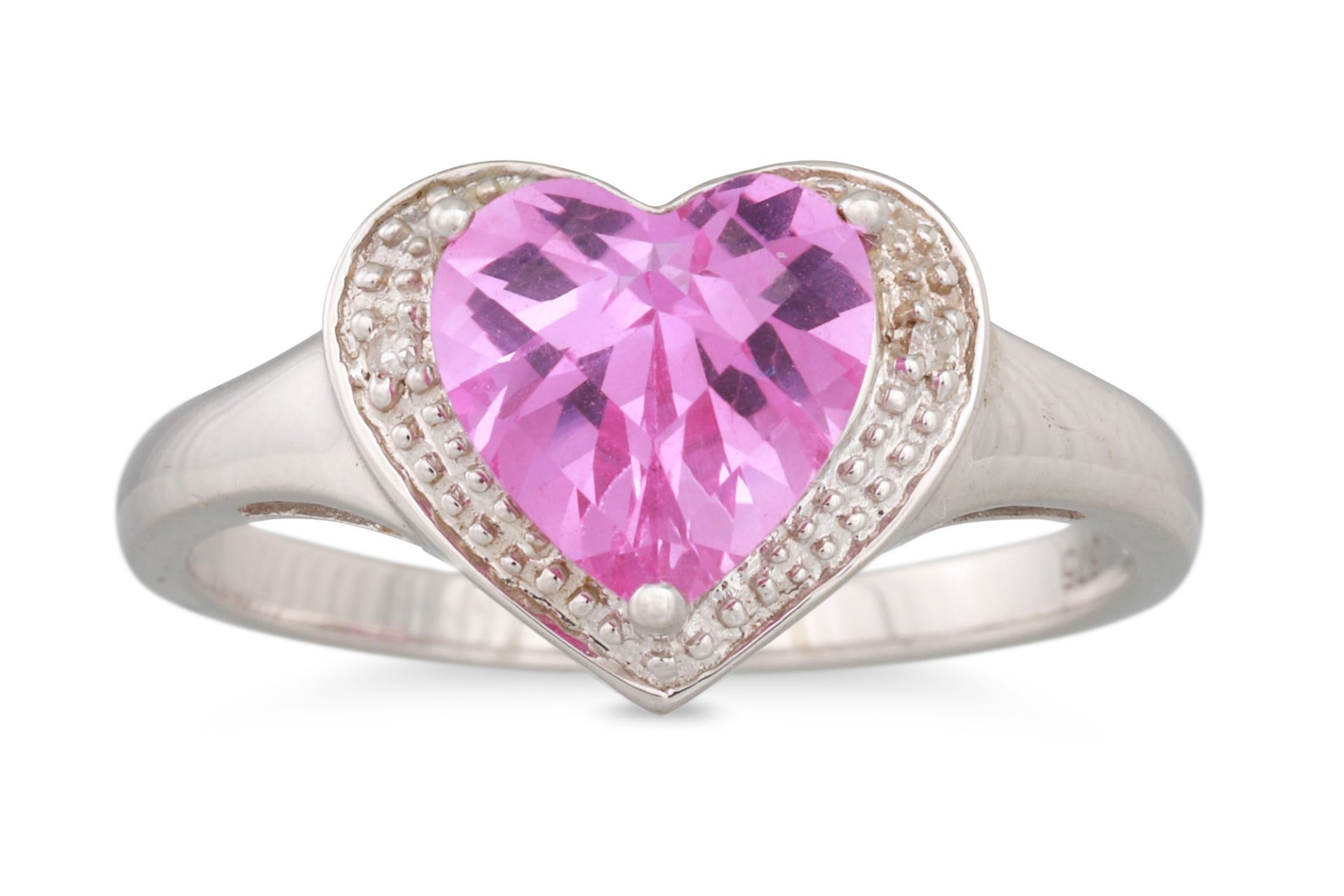 A HEART SHAPED CLUSTER RING, the heart shaped pink stone to diamond accents, mounted in white