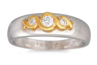 A THREE STONE DIAMOND RING, mounted in 18ct two colour gold, size N