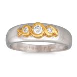 A THREE STONE DIAMOND RING, mounted in 18ct two colour gold, size N