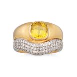 A YELLOW SAPPHIRE AND DIAMOND RING, the princess cut sapphire mounted to an 18ct white and yellow