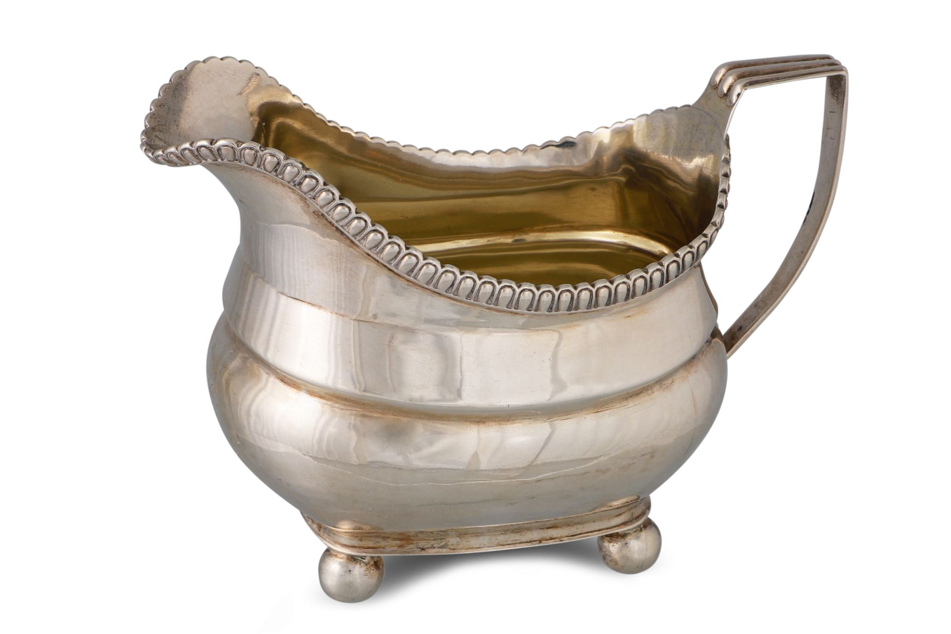 A GEORGE III SILVER MILK JUG, of loaf of bread form, gilded interior, by Thomas Johnston, 124 g.