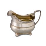 A GEORGE III SILVER MILK JUG, of loaf of bread form, gilded interior, by Thomas Johnston, 124 g.