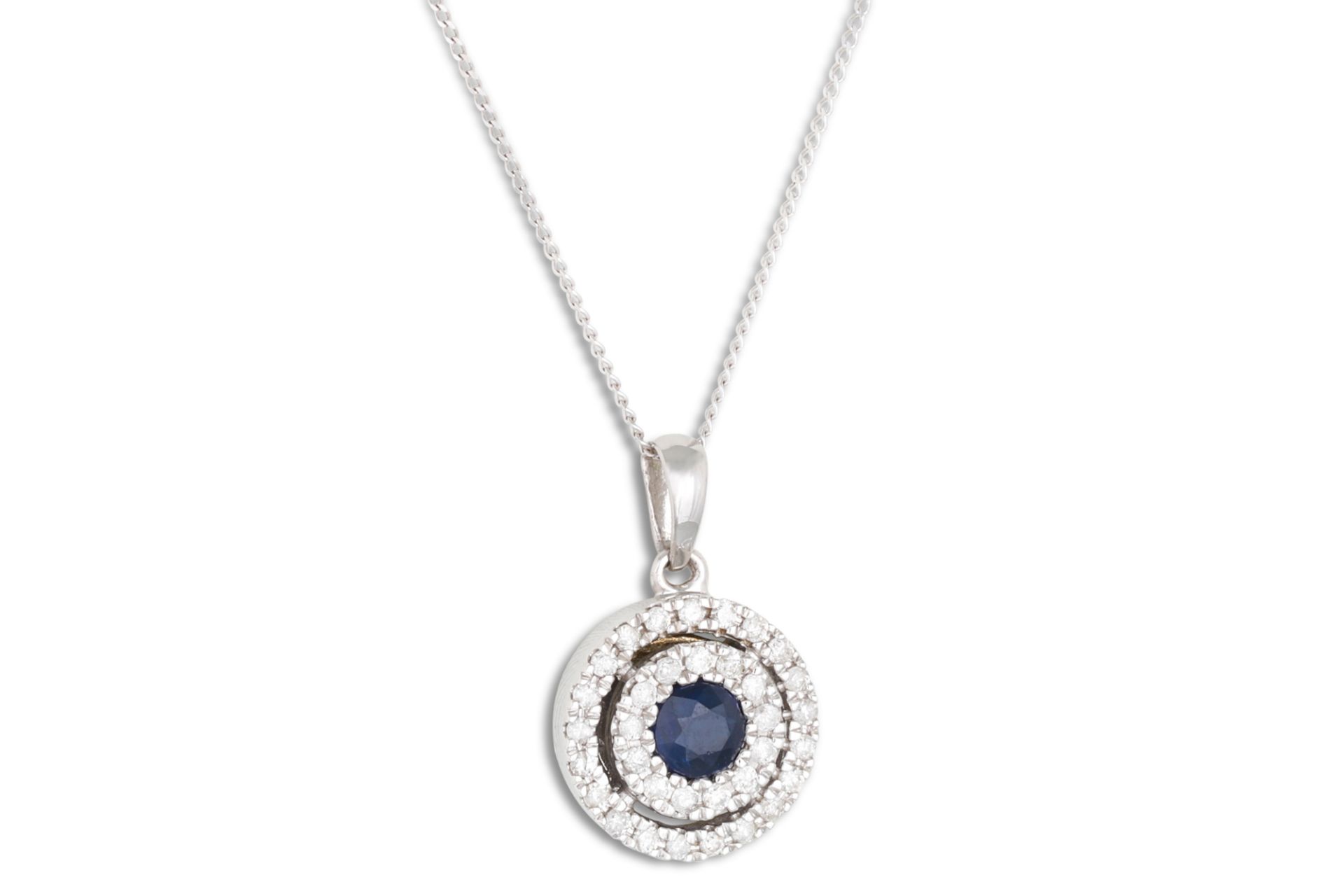 A DIAMOND AND SAPPHIRE TARGET PENDANT, mounted in white gold on a chain
