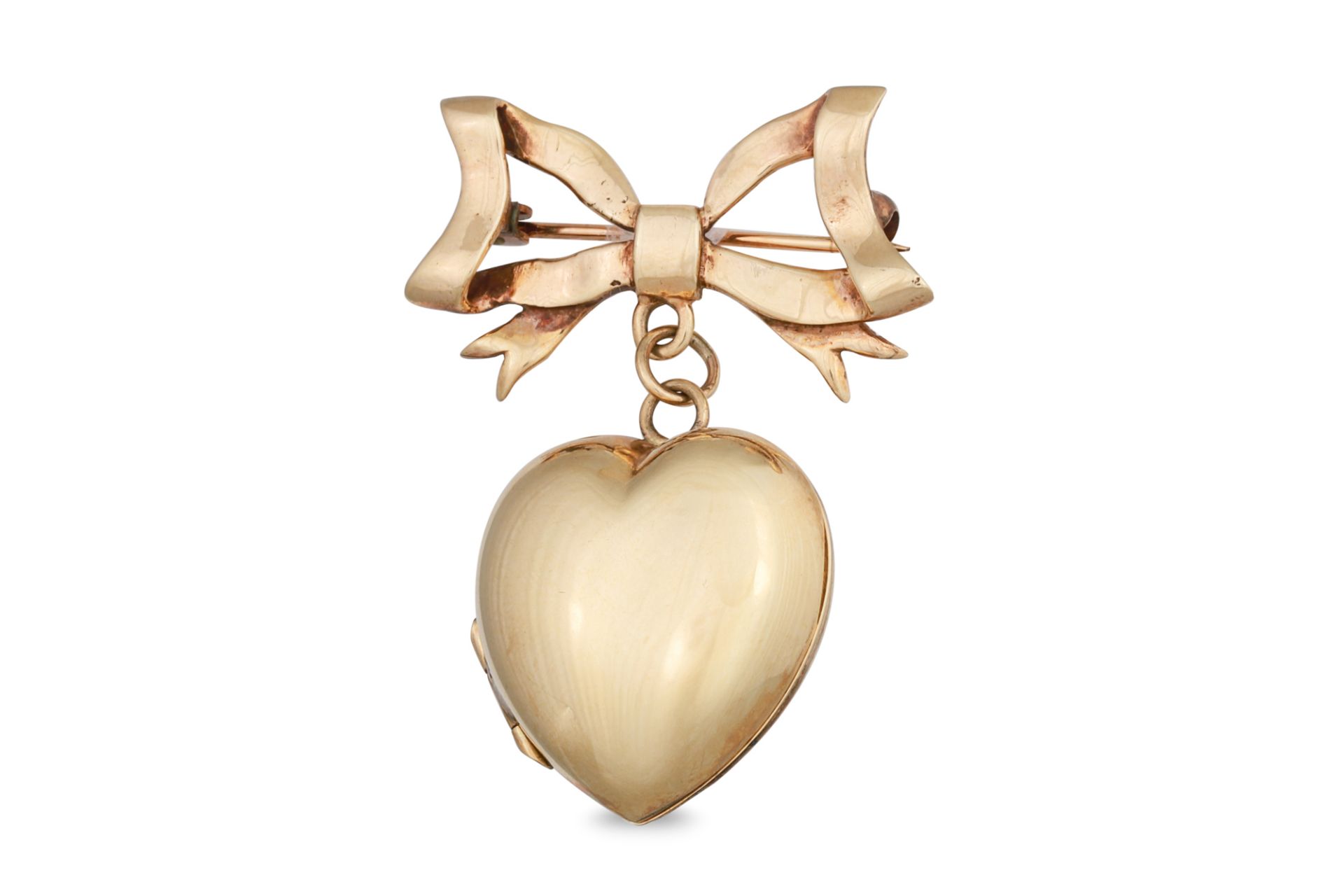 A HEART SHAPED LOCKET, in 9ct gold, suspended from a bow shaped pin, 7.3 g.