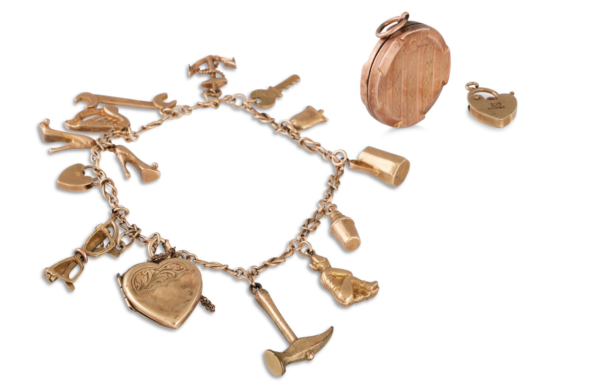 A 9CT GOLD CHARM BRACELET, various charms attached, 21 g.