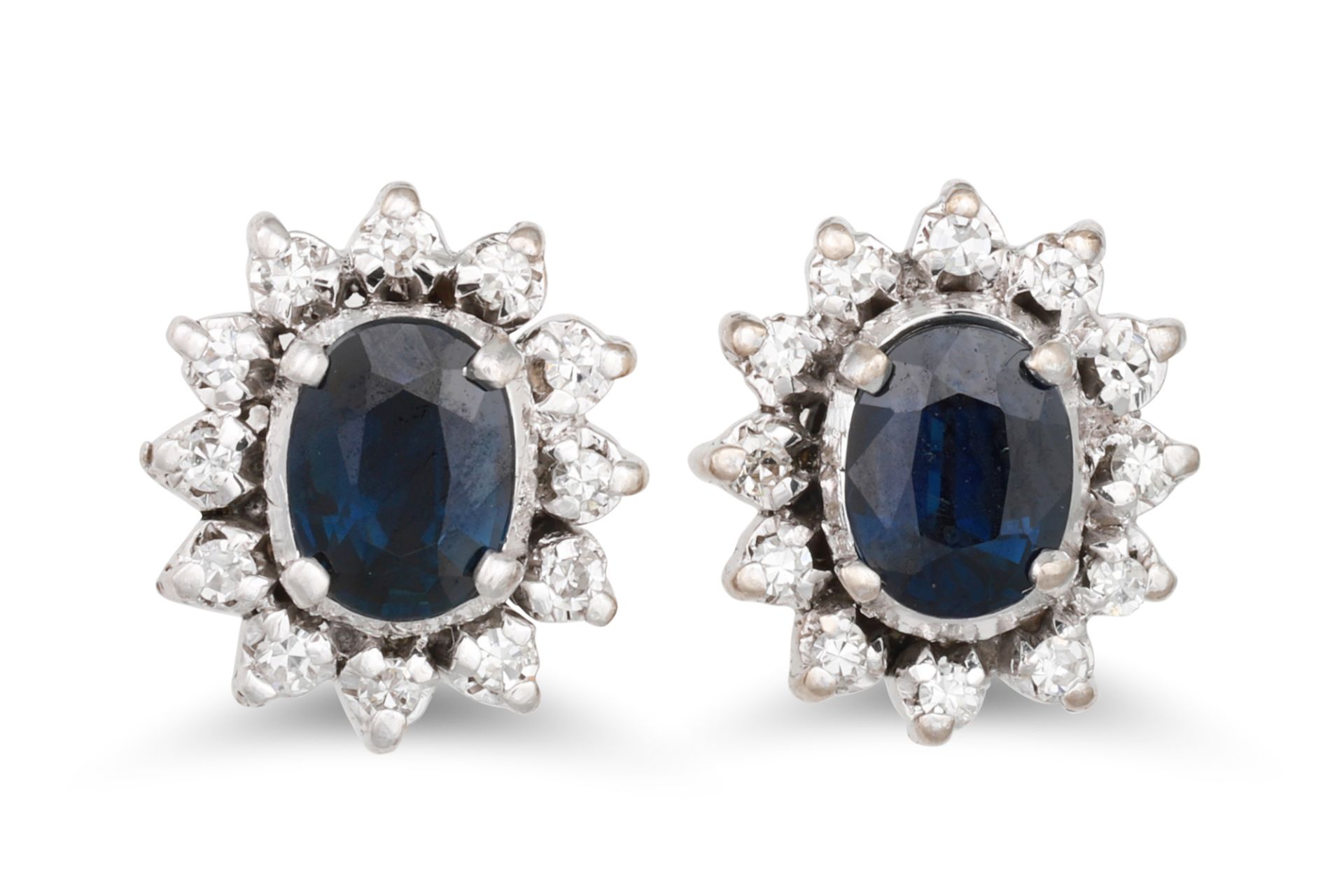 A PAIR OF DIAMOND AND SAPPHIRE CLUSTER EARRINGS, an oval sapphire to diamond surround, mounted in