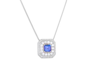 A TANZANITE AND DIAMOND CLUSTER PENDANT, the trap cut tanzanite to a two rowed diamond surround,