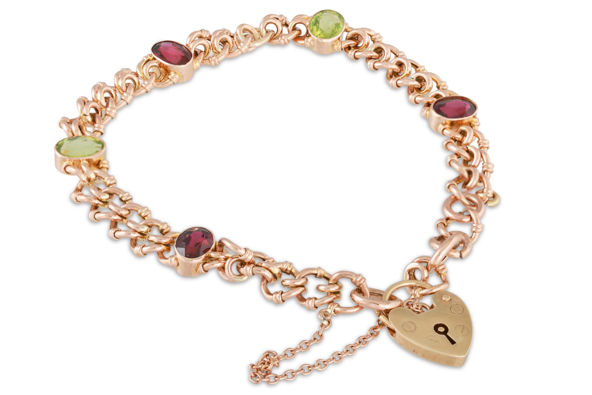 A GARNET AND PERIDOT CURB BRACELET, in gold, with padlock, 13.3 g.