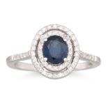 A SAPPHIRE AND DIAMOND CLUSTER RING, the oval sapphire to a two rowed brilliant cut diamond surround