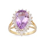 A DIAMOND AND AMETHYST RING, the pear shaped amethyst to diamond surround, mounted in 9ct yellow