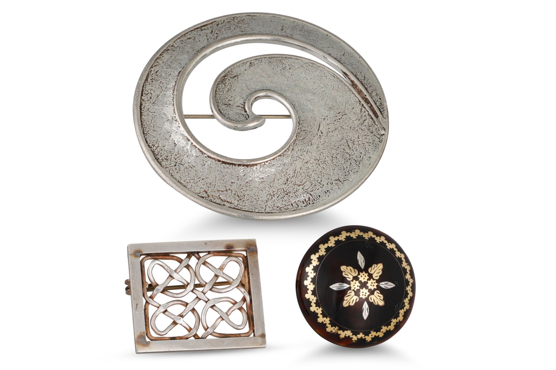 AN ANTIQUE CIRCULAR INLAID TORTOISESHELL BROOCH, together with a Celtic style silver brooch and a