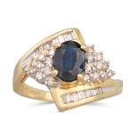 A DIAMOND AND SAPPHIRE CLUSTER RING, the oval sapphire to diamond surround and shoulders, mounted in