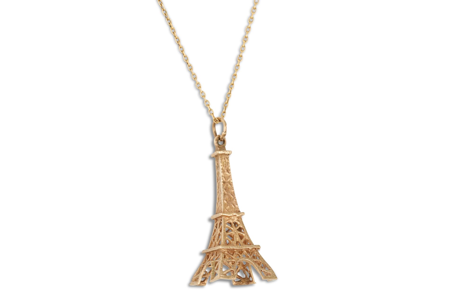 A GOLD CHARM, in the form of the Eiffel Tower, in 9ct gold on a 18ct gold neck chain, gross weight