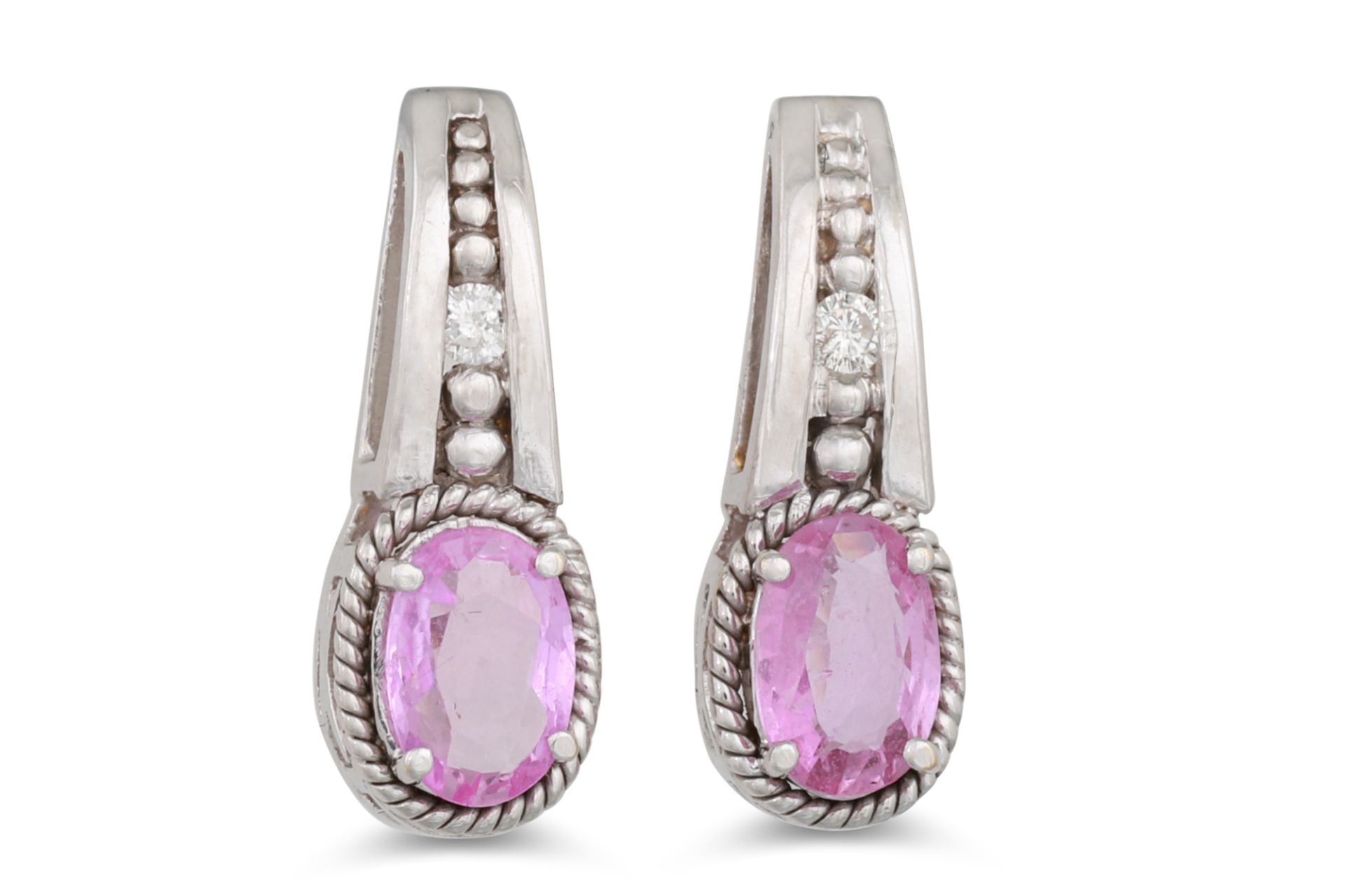 A PAIR OF DIAMOND AND PINK SAPPHIRE EARRINGS, the oval sapphire to diamond surround mounted in white