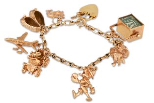 A 9CT GOLD CHARM BRACELET, with various charms attached, gross weight 37 g.