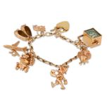 A 9CT GOLD CHARM BRACELET, with various charms attached, gross weight 37 g.
