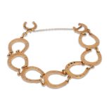 A 9CT GOLD HORSE SHOE LINK BRACELET, 12.1 g.