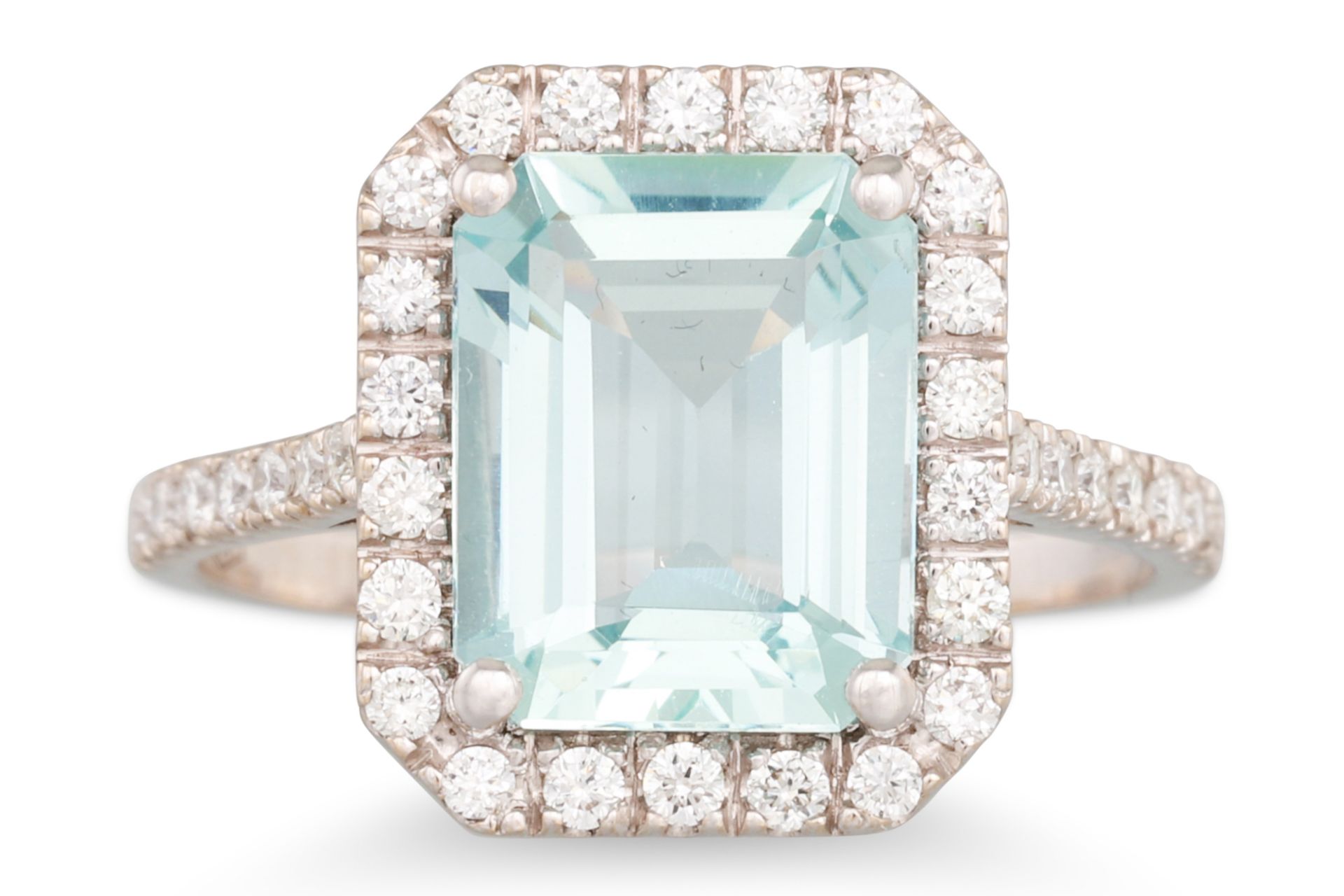 AN AQUAMARINE AND DIAMOND CLUSTER RING, the rectangular aquamarine to a brilliant cut diamond