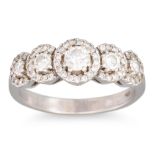 A FIVE STONE DIAMOND RING, the graduated halo set diamonds mounted in 18ct white gold, size N