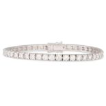 A DIAMOND LINE BRACELET, the round brilliant cut diamonds mounted in 18ct white gold. Together