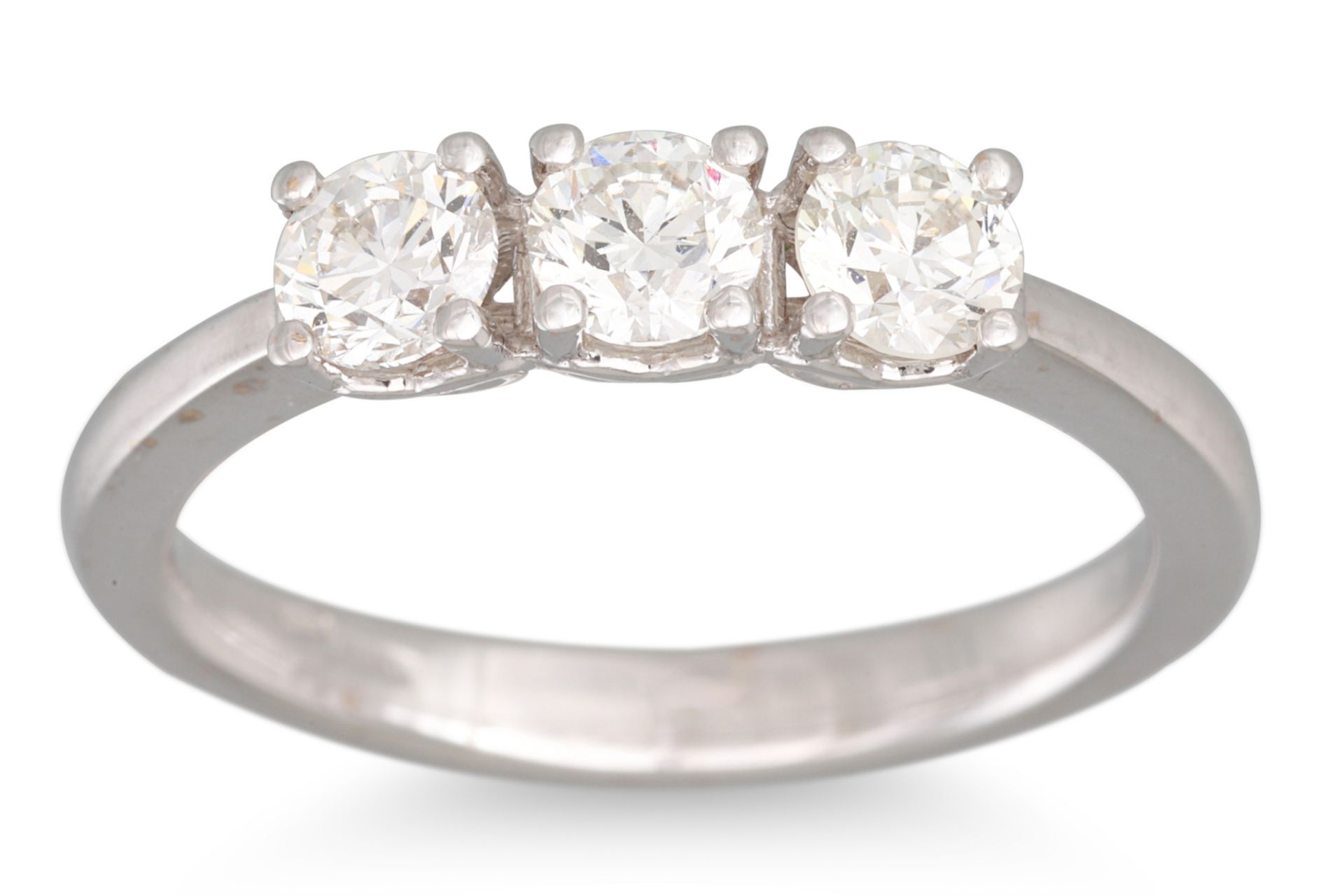 A THREE STONE DIAMOND RING, mounted in 18ct white gold. Estimated: weight of diamonds: 0.90 ct.