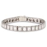 A DIAMOND LINE BRACELET, set with thirty-two round brilliant cut diamonds, mounted in white gold.