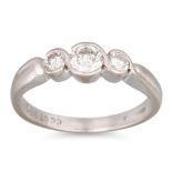 A THREE STONE DIAMOND RING, mounted in platinum. Size: L