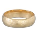 A VINTAGE GOLD HINGED HOLLOW BANGLE, with engraved decoration, 24 g. *** testing as 55%