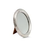 AN EDWARDIAN SILVER CIRCULAR PHOTO MIRROR FRAME, the large mounted border with hallmark Birmingham