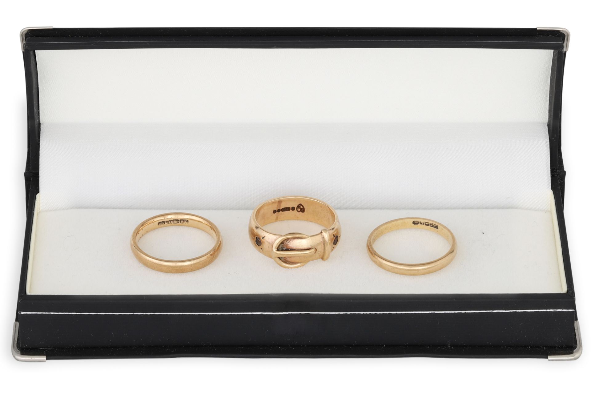 A 9CT GOLD BUCKLE RING, together with two band rings, 9.9 g. Size: M x 2, N