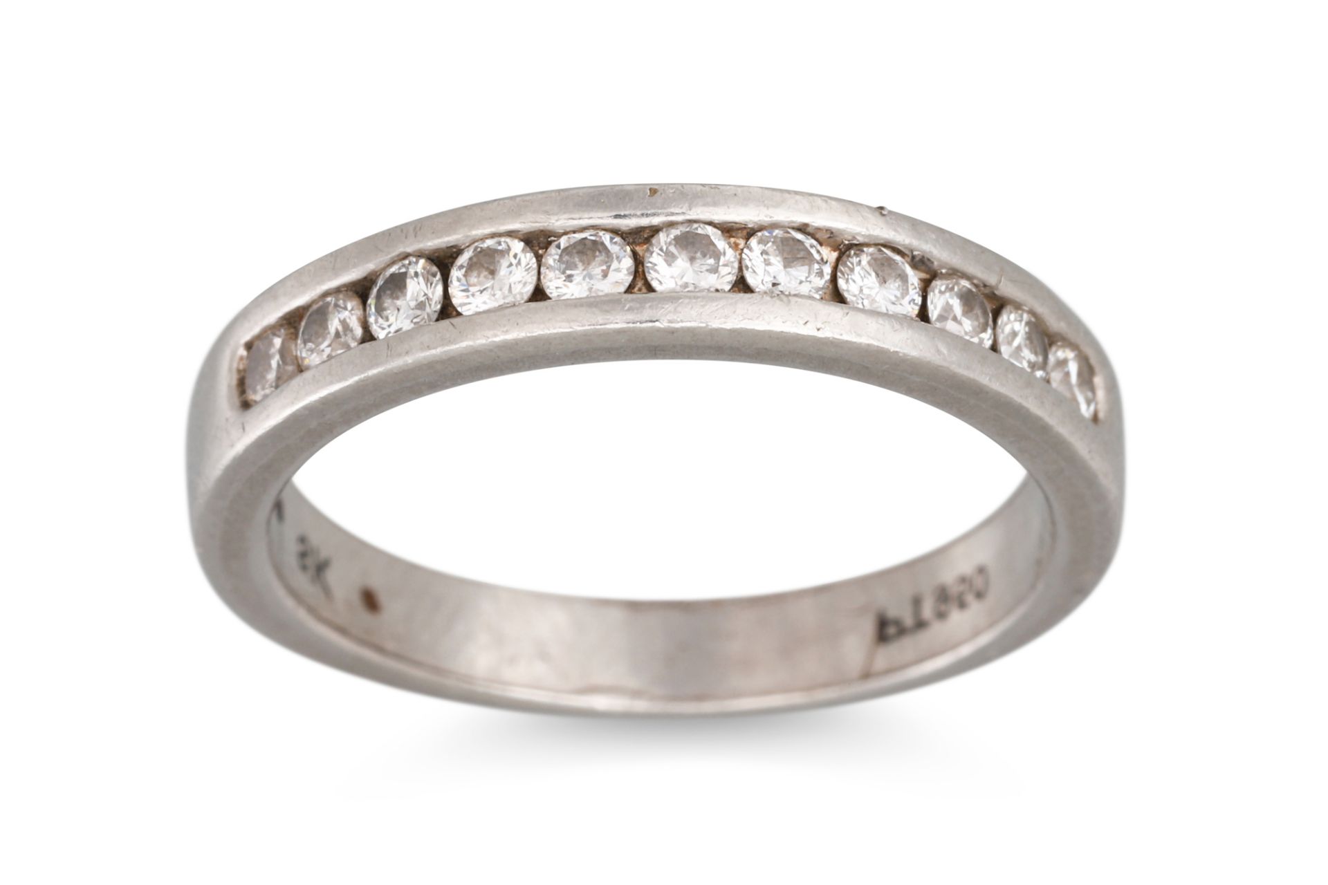 A DIAMOND SET BAND RING, the eleven brilliant cut diamonds channel set in platinum, size J