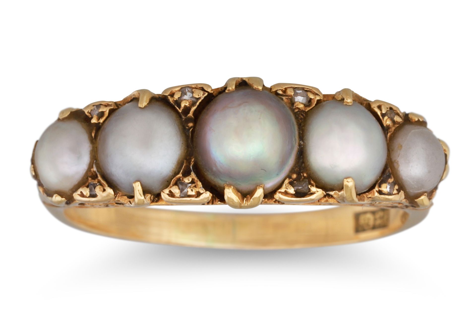 AN ANTIQUE FIVE STONE PEARL RING, with diamond points, in a 18ct yellow gold carved mount. Size: P