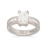 A DIAMOND SOLITAIRE RING, the emerald cut diamond to diamond set shoulders, mounted in 18ct white
