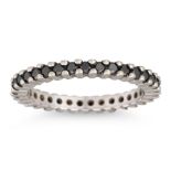 AN ETERNITY RING, black stone set, mounted in 18ct white gold, size J