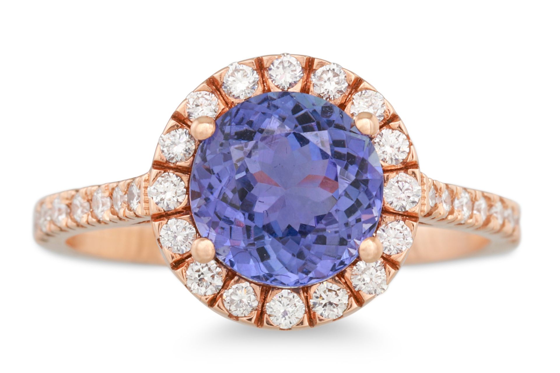 A TANZANITE AND DIAMOND CLUSTER RING, the circular stones to diamond surround and shoulders, mounted