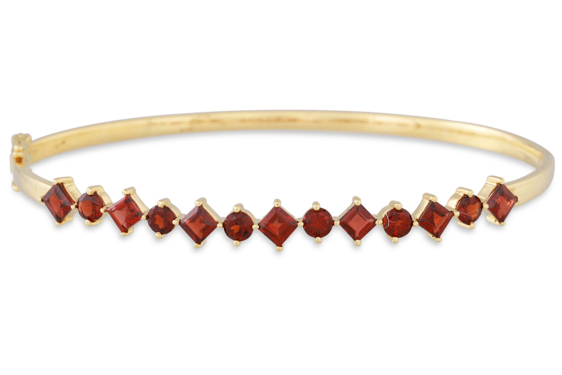 A GARNET AND GOLD HINGED BANGLE, the round and square garnet mounted in 18ct gold, 10.3 g.