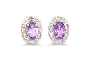 A PAIR OF DIAMOND AND AMETHYST CLUSTER EARRINGS, the oval amethyst to diamond surround, mounted in