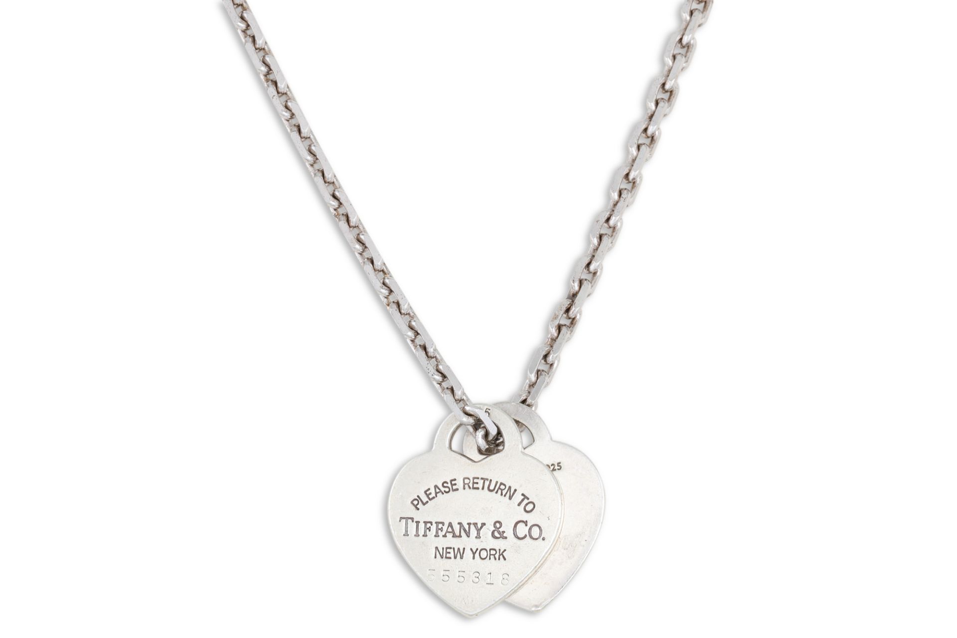 A SILVER TIFFANY PENDANT, stamped 'I Love you, Tiffany & Co.' on a silver chain