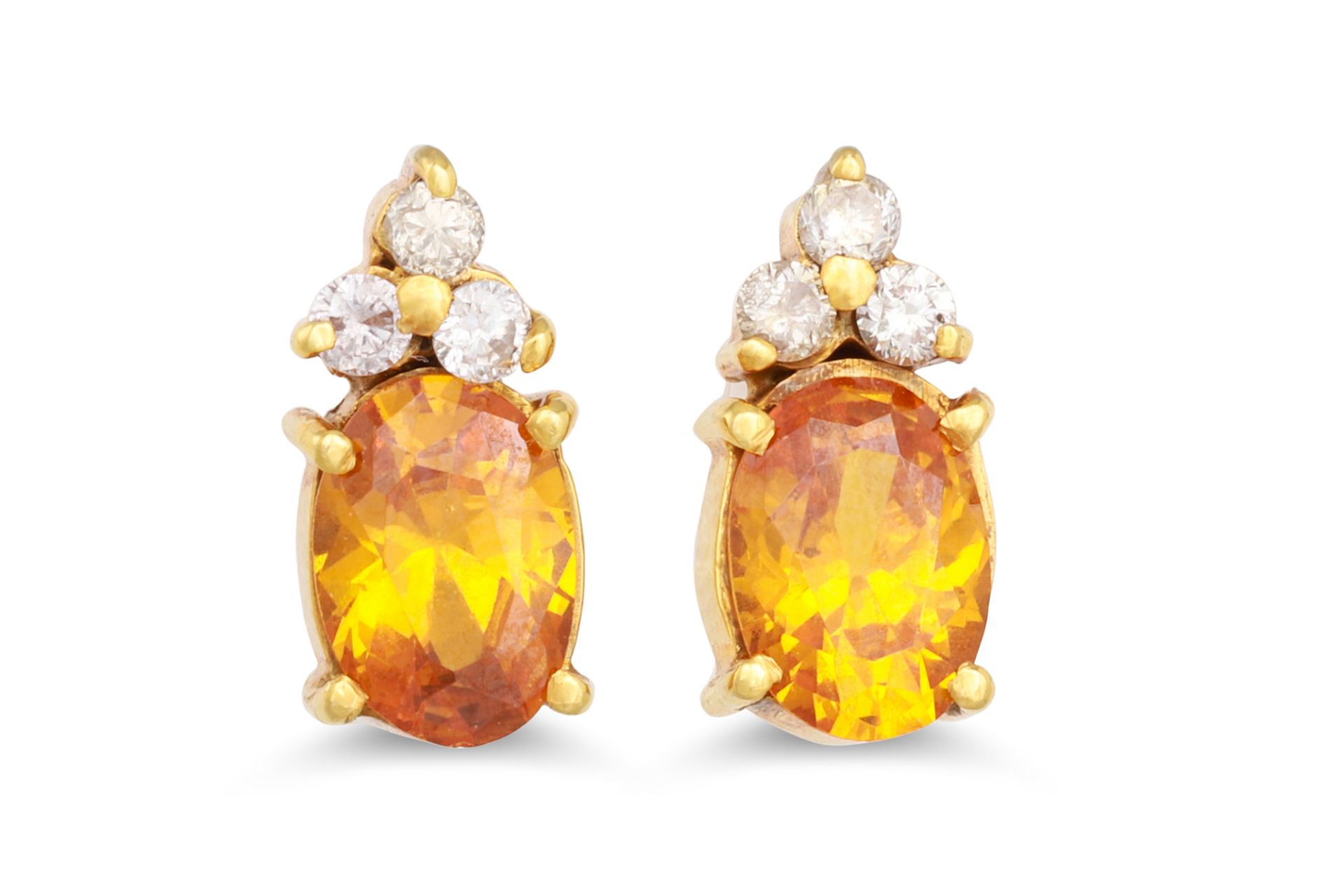 A PAIR OF DIAMOND AND YELLOW SAPPHIRE EARRINGS, the oval sapphire to diamond surround, mounted in