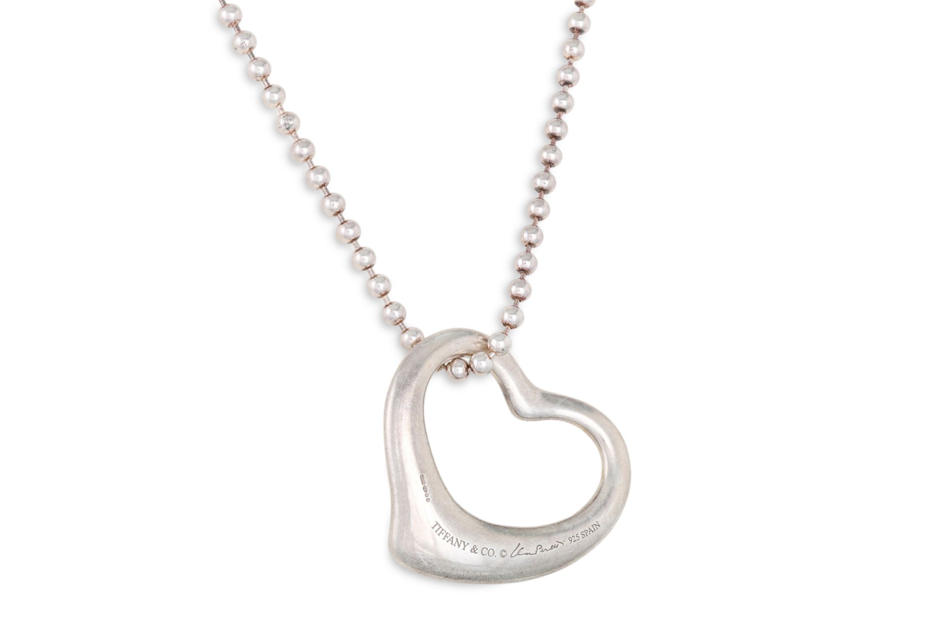 A SILVER TIFFANY HEART PENDANT, by Elsa Peretti, on a silver chain