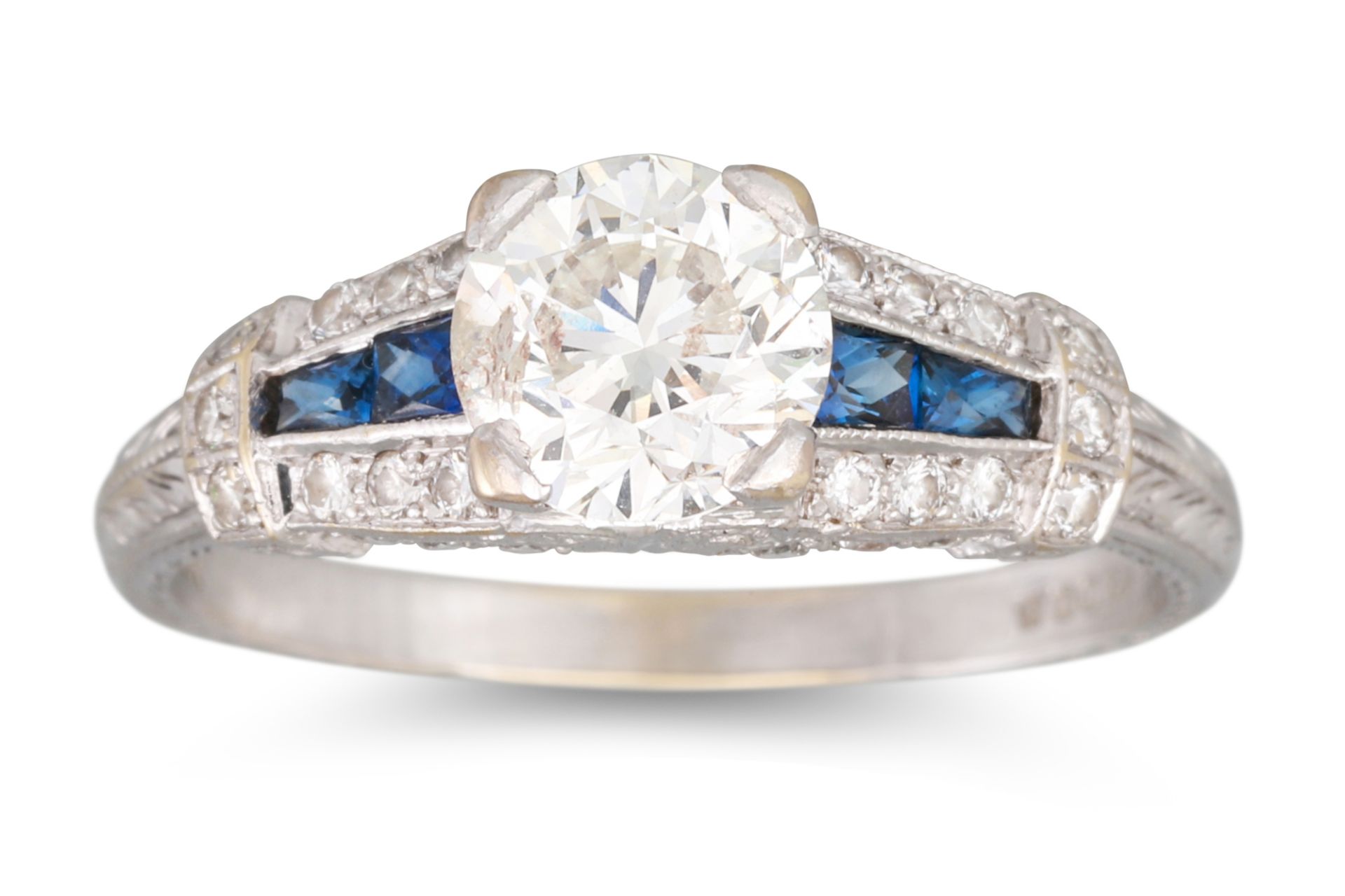 A DIAMOND AND SAPPHIRE RING, the brilliant cut diamond to a channel set sapphire and diamond