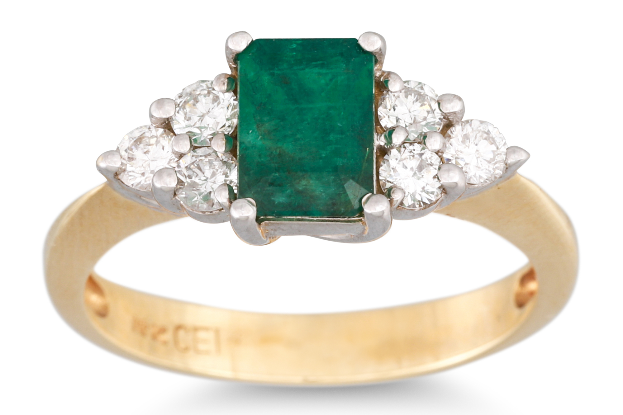 AN EMERALD AND DIAMOND THREE STONE RING, the rectangular emerald to diamond trio sides, mounted in